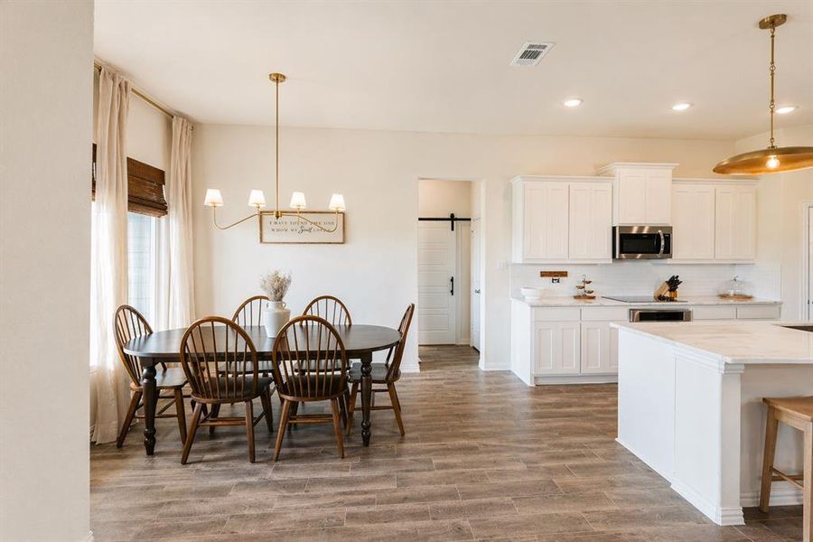Open-concept living space featuring wood-finish flooring