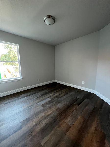 Unfurnished room featuring dark hardwood / wood-style floors