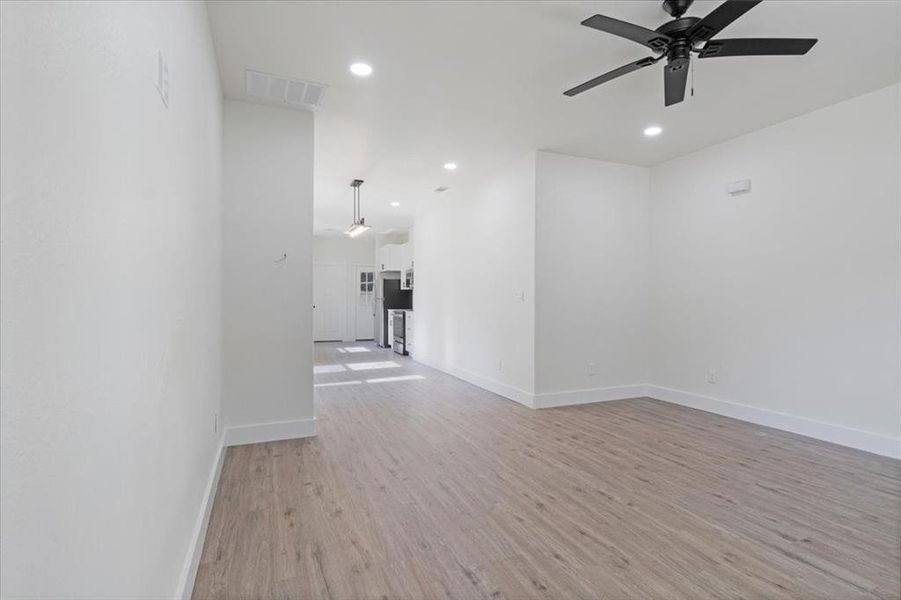 Spare room featuring ceiling fan and light hardwood / wood-style flooring