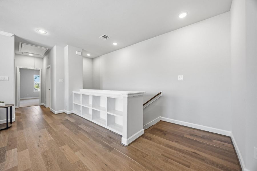 Entertainer's Nook: This game room is perfectly appointed with built-in shelves to showcase your interests and a ceiling fan above to ensure a cool, inviting atmosphere for every play.