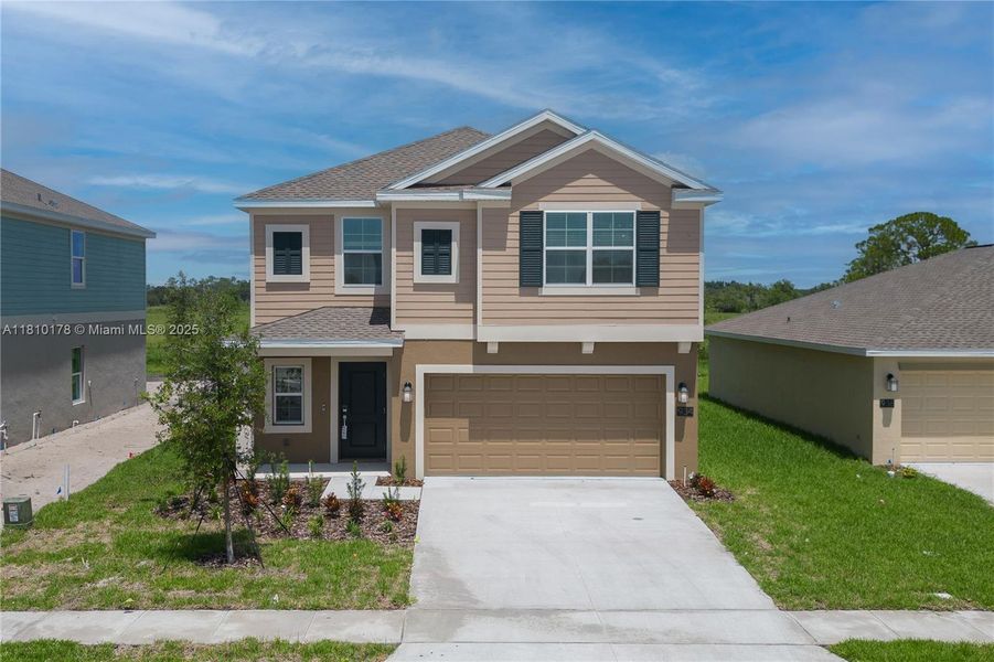 Front exterior of a new home in Inman Groves, Winter Haven, FL, highlighting curb appeal (Image 23). Front exterior of a new home in Inman Groves, Winter Haven, FL, highlighting curb appeal (Image 23).