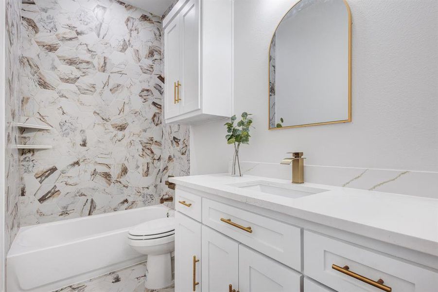 Full bathroom with vanity, shower / bath combination, and toilet