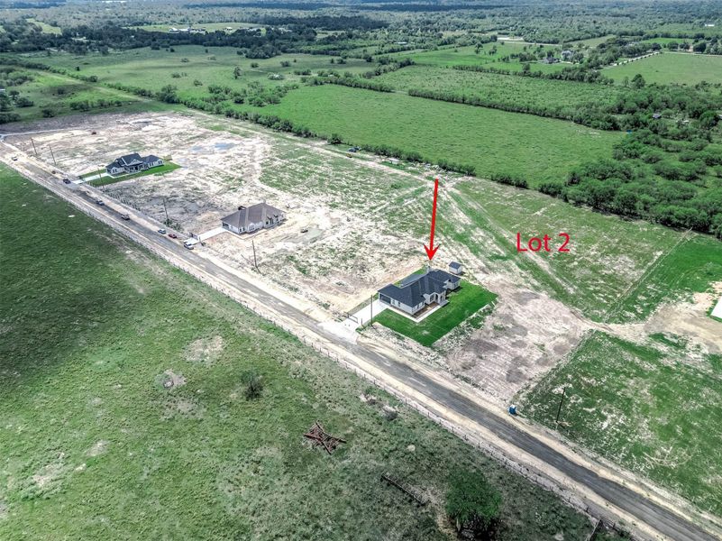 Aerial view showing the home’s location on **Lot 2** and the surrounding area. Aerial view showing the home’s location on **Lot 2** and the surrounding area.