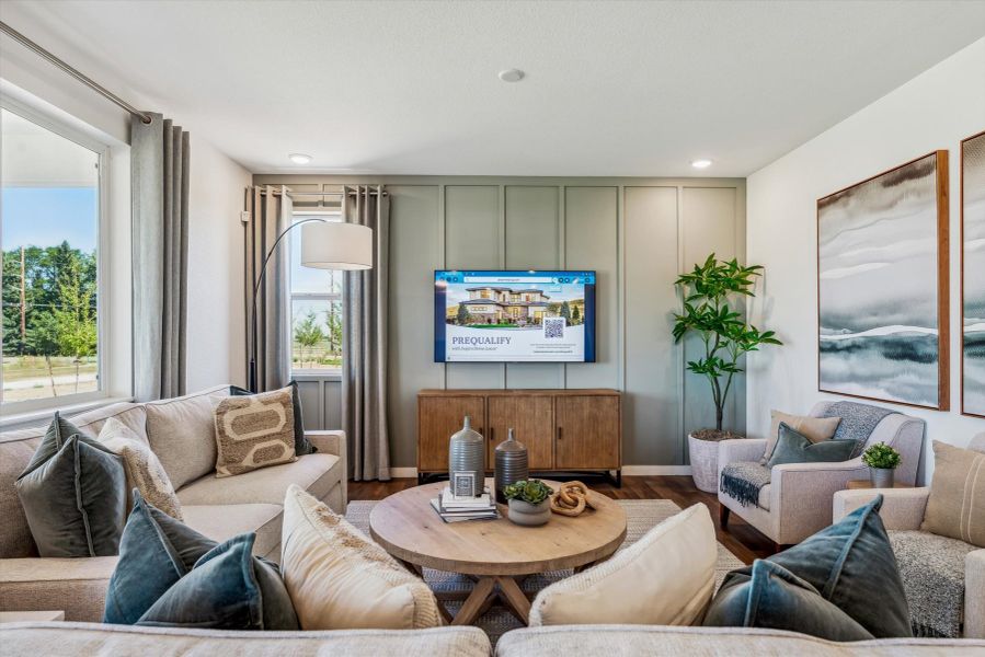 A living room with a tv and couches. A living room with a tv and couches.