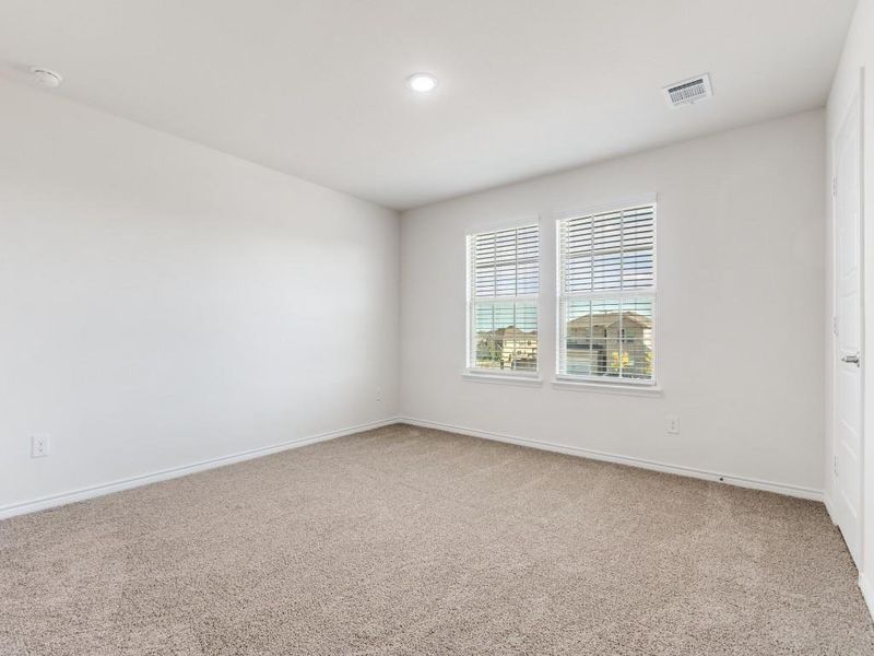 Unfurnished room featuring baseboards and light carpet