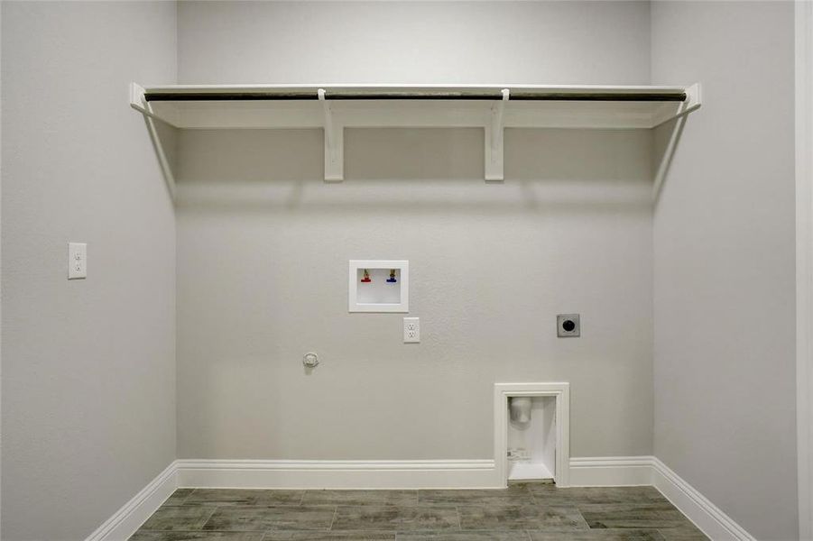 Laundry area featuring electric dryer hookup, hookup for a gas dryer, washer hookup, and wood tiled floors