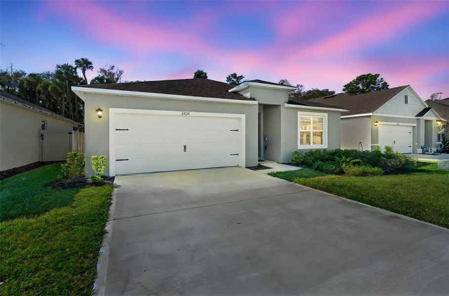 Front exterior of a new home in Oak Leaf Preserve, New Smyrna Beach, FL, highlighting curb appeal (Image 26). Front exterior of a new home in Oak Leaf Preserve, New Smyrna Beach, FL, highlighting curb appeal (Image 26).
