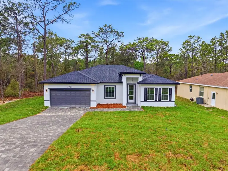 Front exterior of a new home in , Citrus Springs, FL, highlighting curb appeal (Image 18).