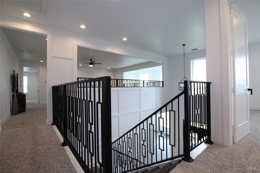 Corridor featuring carpet flooring, an upstairs landing, and recessed lighting Corridor featuring carpet flooring, an upstairs landing, and recessed lighting