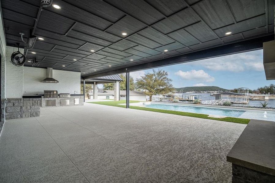 Outdoor kitchen with pool and lake view