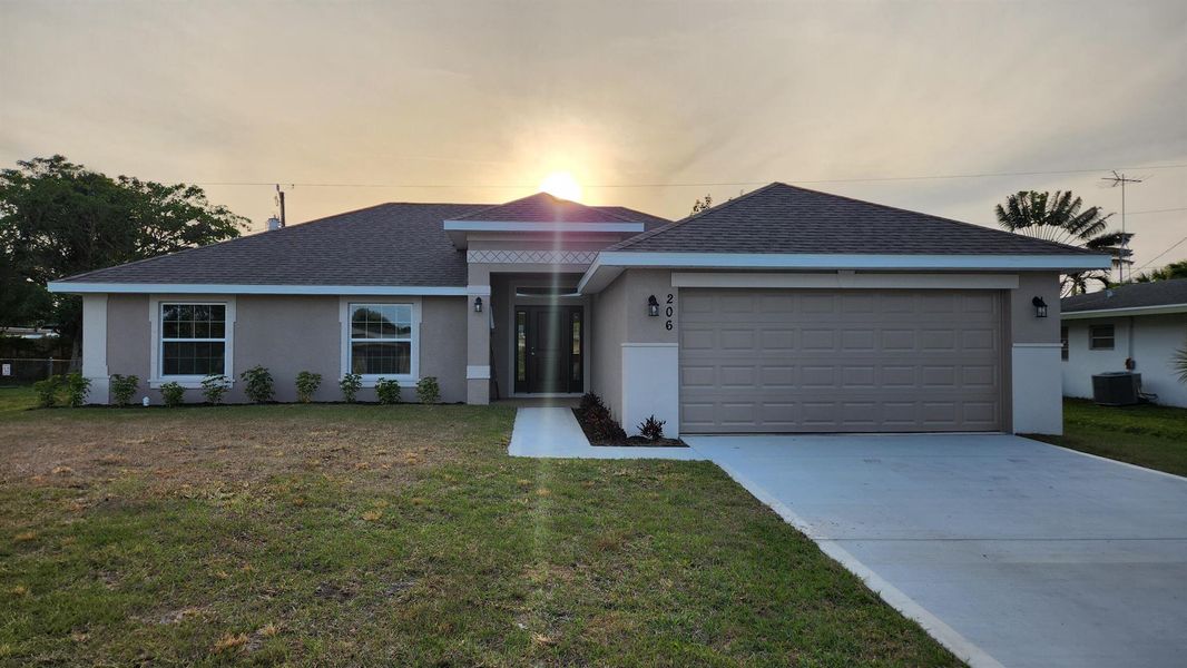 Front exterior of a new home in Gatlin, Port St. Lucie, FL, highlighting curb appeal (Image 2).
