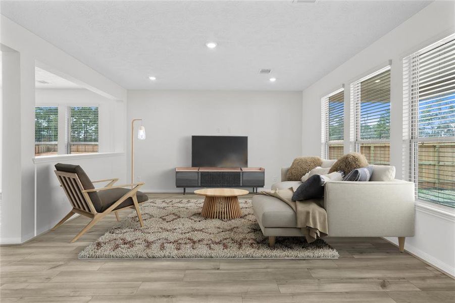 Gather the family and guests together in your lovely family room! Featuring high ceilings, recessed lighting, custom paint, gorgeous vinyl plank flooring and large windows that provide plenty of natural lighting throughout the day.