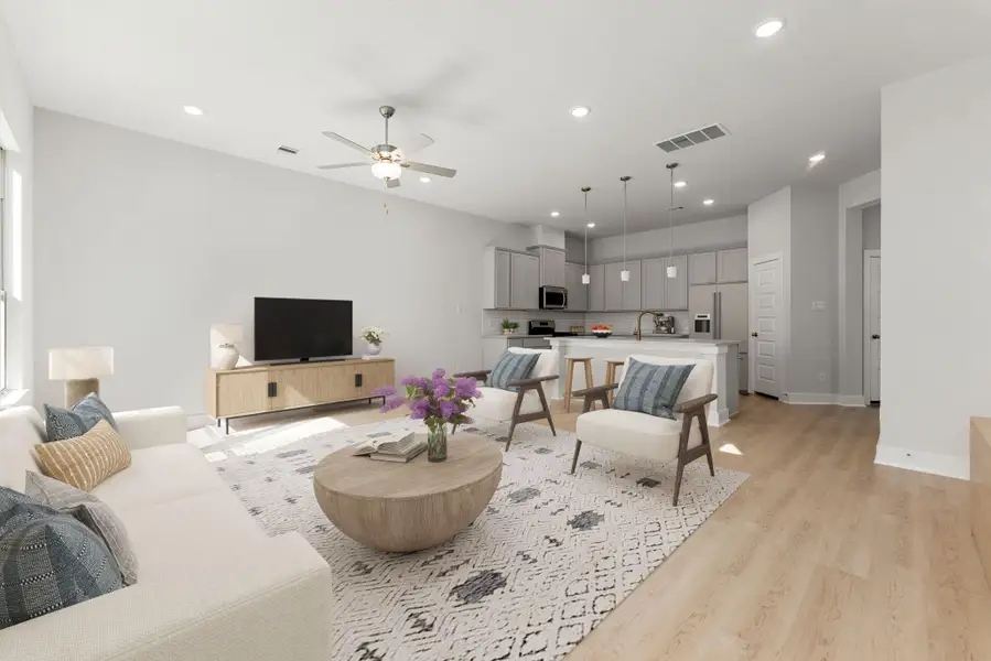 This bright and inviting living area offers an open-concept design that seamlessly connects to the kitchen and dining spaces. Neutral tones, recessed lighting, and wide-plank flooring create a modern yet comfortable atmosphere, while large windows fill the space with natural light, making it an ideal setting for relaxing or entertaining. This bright and inviting living area offers an open-concept design that seamlessly connects to the kitchen and dining spaces. Neutral tones, recessed lighting, and wide-plank flooring create a modern yet comfortable atmosphere, while large windows fill the space with natural light, making it an ideal setting for relaxing or entertaining.