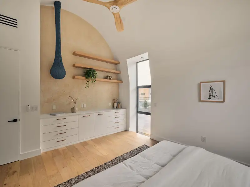 Bedroom featuring light wood flooring and ceiling fan Bedroom featuring light wood flooring and ceiling fan