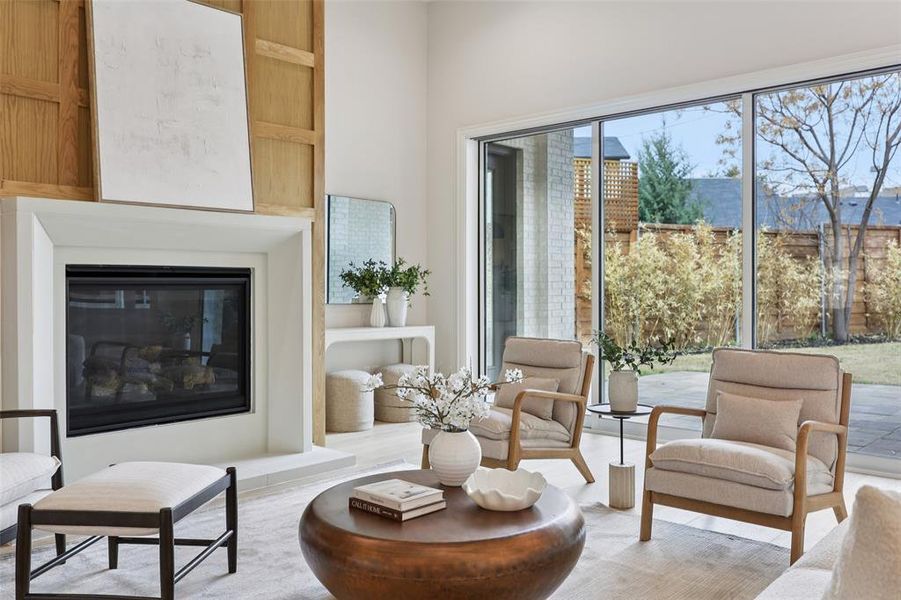 Living area with a glass covered fireplace and wood finished floors