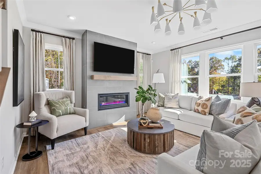 Cozy great room at the heart of the home featuring a gas fireplace. *Model Photos | Actual finishes, structural selections, and orientation may vary. Cozy great room at the heart of the home featuring a gas fireplace. *Model Photos | Actual finishes, structural selections, and orientation may vary.