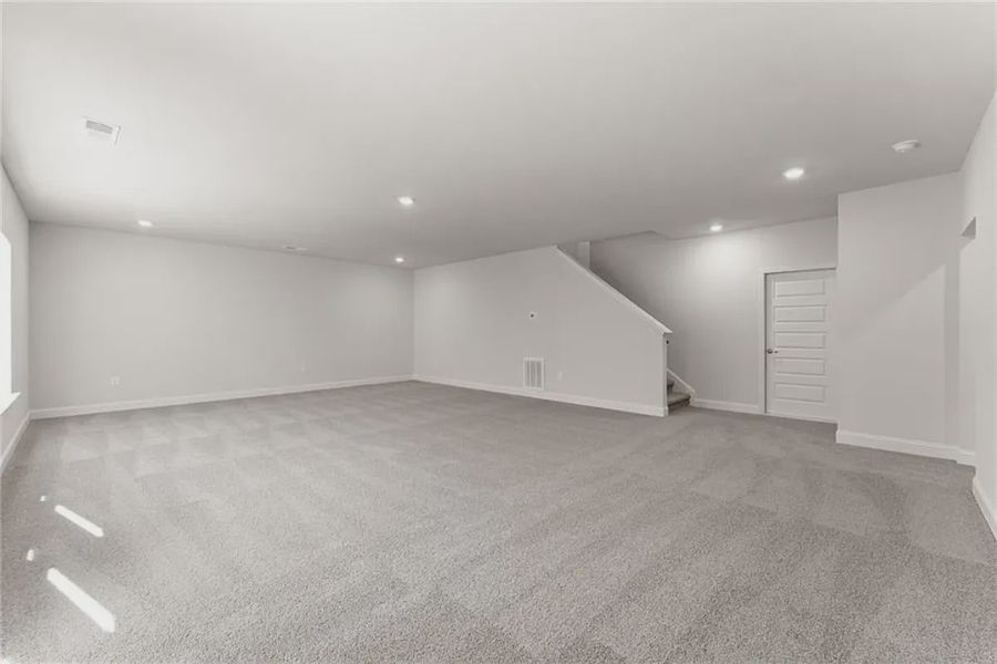 Representative unfurnished interior of a home built from the 1709 by Adams Homes in Chambers Landing, Commerce (Image 31).