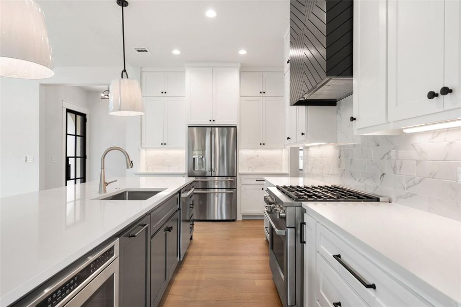 Culinary excellence awaits in this well-appointed kitchen, featuring a central island and contemporary stainless appliances.