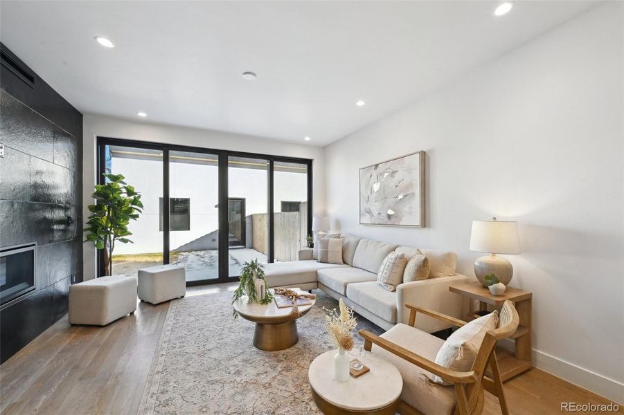 Family room with fireplace, opening onto backyard