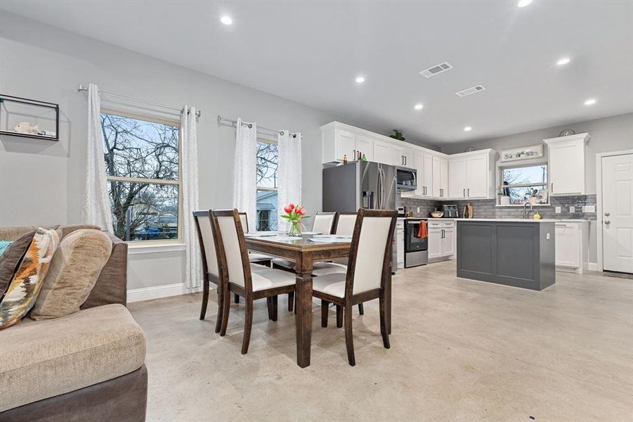 Dining space with plenty of natural light and sink