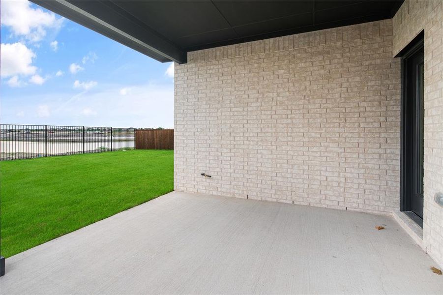 Exterior details and patio area of a home in Walden Pond, Forney (Image 19).