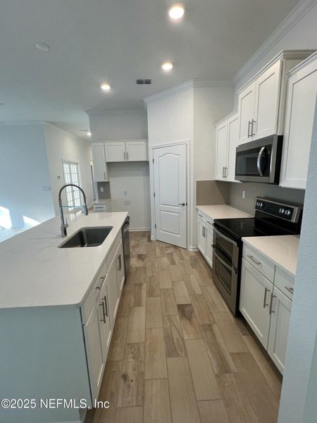 Furnished interior in a model home at American Village in Palm Coast (Image 10).