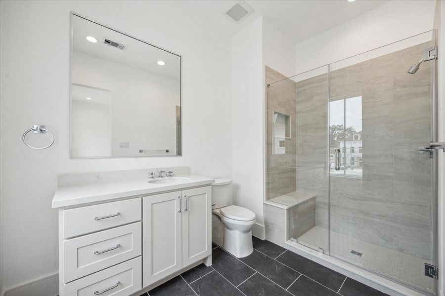 En-suite bathroom for final second-floor bathroom features a sleek, glass-encased shower, Quartz counters and additional counter and storage space. En-suite bathroom for final second-floor bathroom features a sleek, glass-encased shower, Quartz counters and additional counter and storage space.