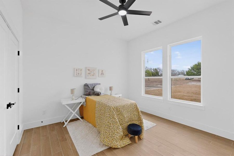 Bedroom featuring light wood-style floors and ceiling fan
