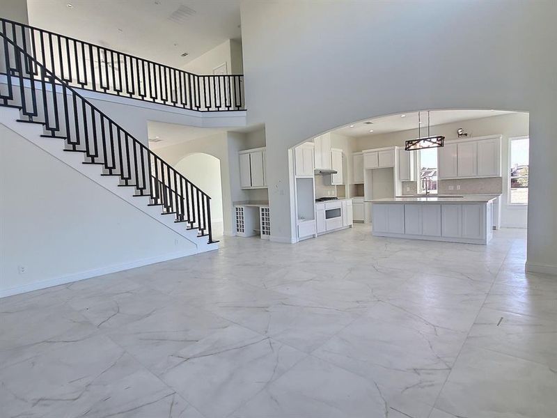 Unfurnished living room featuring a high ceiling - Open floor plan