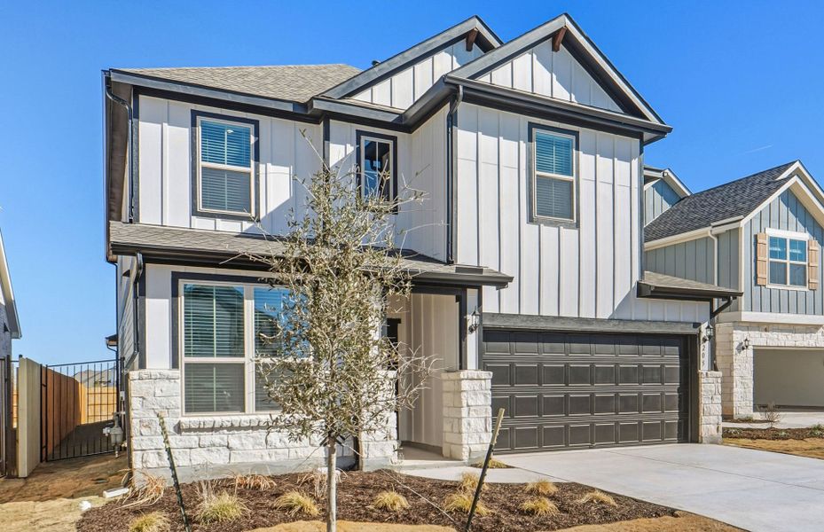 Front exterior of a new home in Santa Rita Ranch, Liberty Hill, TX, highlighting curb appeal (Image 1). Front exterior of a new home in Santa Rita Ranch, Liberty Hill, TX, highlighting curb appeal (Image 1).