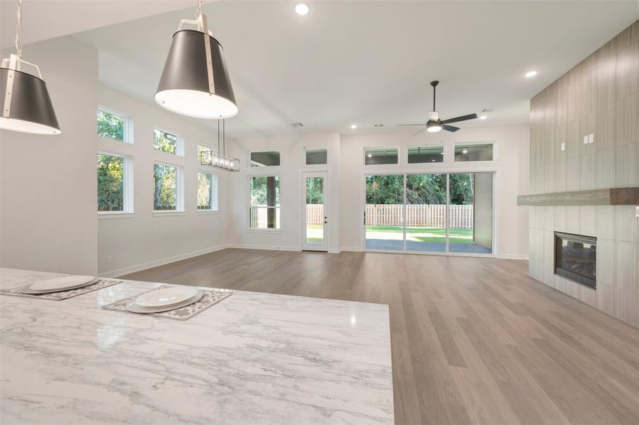 Spacious Living and dining area with 12 ft ceilings and a beautiful fireplace wall!