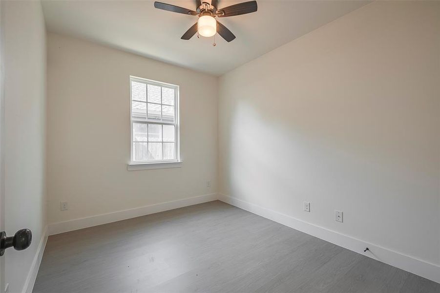 Empty room featuring ceiling fan and light wood-type flooring