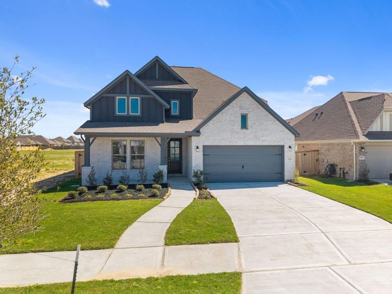 Front exterior of a new home in Valencia, Manvel, TX, highlighting curb appeal (Image 23). Front exterior of a new home in Valencia, Manvel, TX, highlighting curb appeal (Image 23).