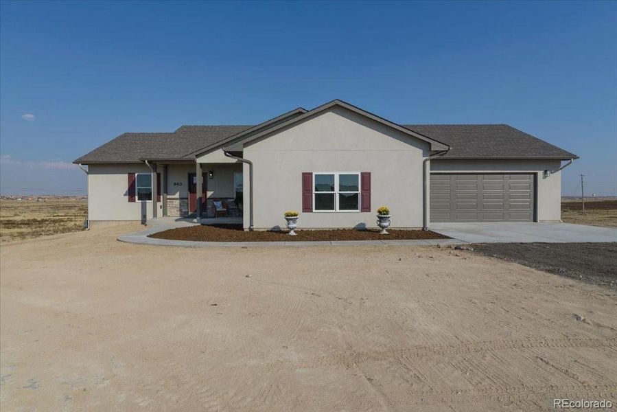 Front exterior of a new home in , Pueblo West, CO, highlighting curb appeal (Image 25).
