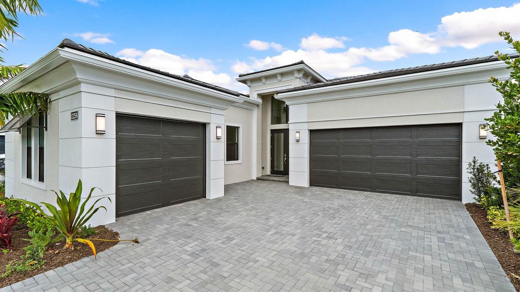 Front exterior of a new home in Artistry Palm Beach, Palm Beach Gardens, FL, highlighting curb appeal (Image 15).