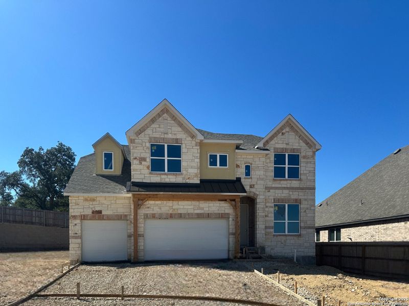 Front exterior of a new home in Sunday Creek at Kinder Ranch, San Antonio, TX, highlighting curb appeal (Image 1). Front exterior of a new home in Sunday Creek at Kinder Ranch, San Antonio, TX, highlighting curb appeal (Image 1).