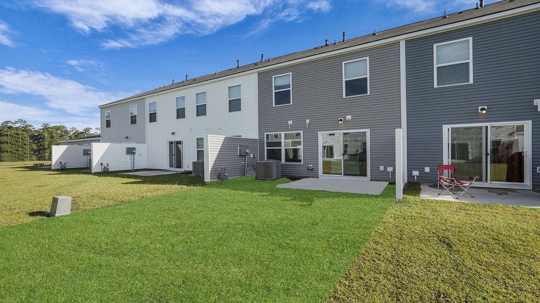 Exterior details and patio area of a home in Pine Hills Townhomes at Cane Bay, Summerville (Image 2).