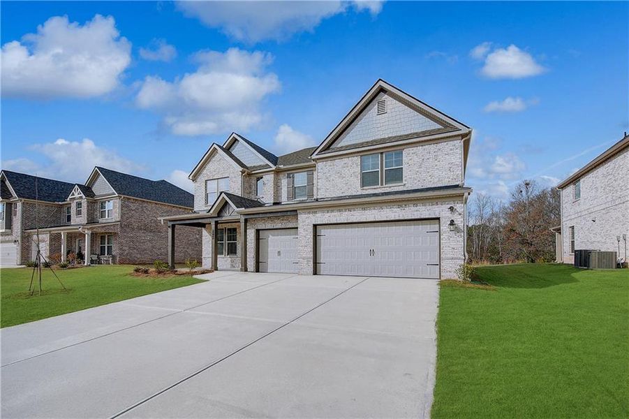 Front exterior of a new home in Adagio, Dacula, GA, highlighting curb appeal (Image 2). Front exterior of a new home in Adagio, Dacula, GA, highlighting curb appeal (Image 2).