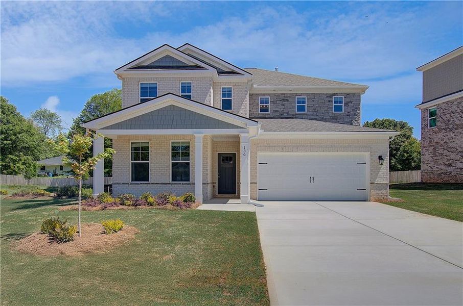 Front exterior of a new home in Bowers Farm, McDonough, GA, highlighting curb appeal (Image 2). Front exterior of a new home in Bowers Farm, McDonough, GA, highlighting curb appeal (Image 2).