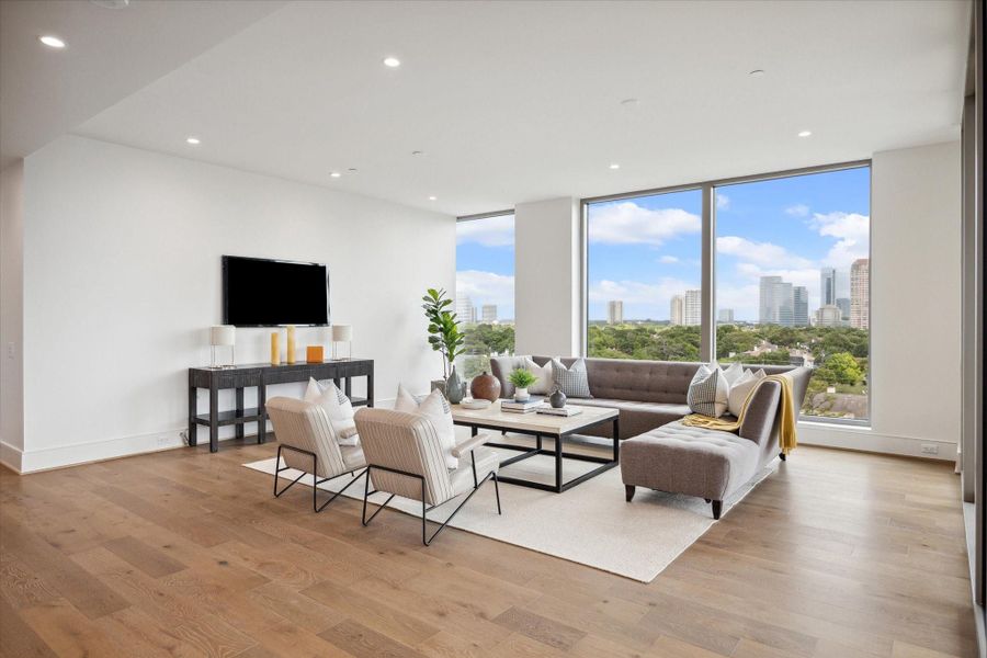 Floor-to-ceiling windows showcase panoramic views of the city.