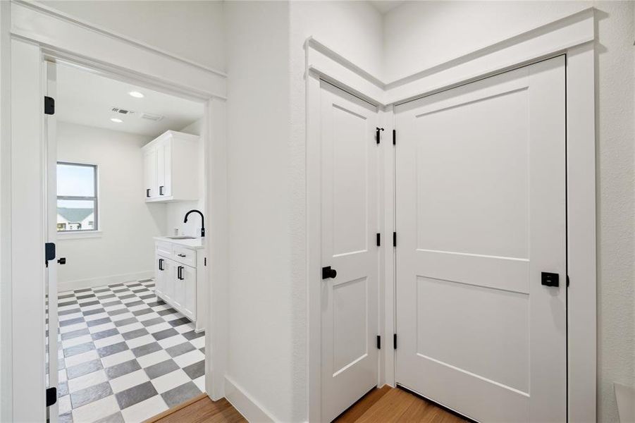 Hallway featuring light hardwood / wood-style floors and sink