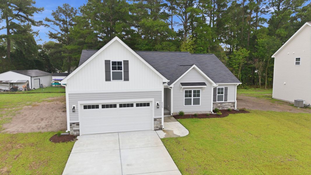 Front exterior of a new home in Davenport Farms, Winterville, NC, highlighting curb appeal (Image 24). Front exterior of a new home in Davenport Farms, Winterville, NC, highlighting curb appeal (Image 24).
