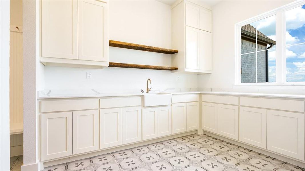 Kitchen featuring sink and white cabinets