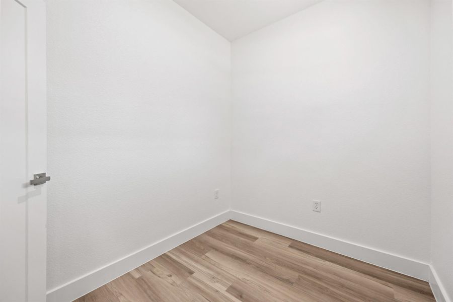 Spare room featuring baseboards and light wood-style flooring