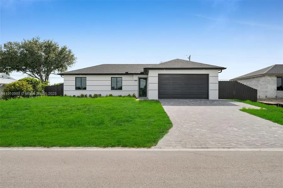 Front exterior of a new home in , Cape Coral, FL, highlighting curb appeal (Image 2). Front exterior of a new home in , Cape Coral, FL, highlighting curb appeal (Image 2).