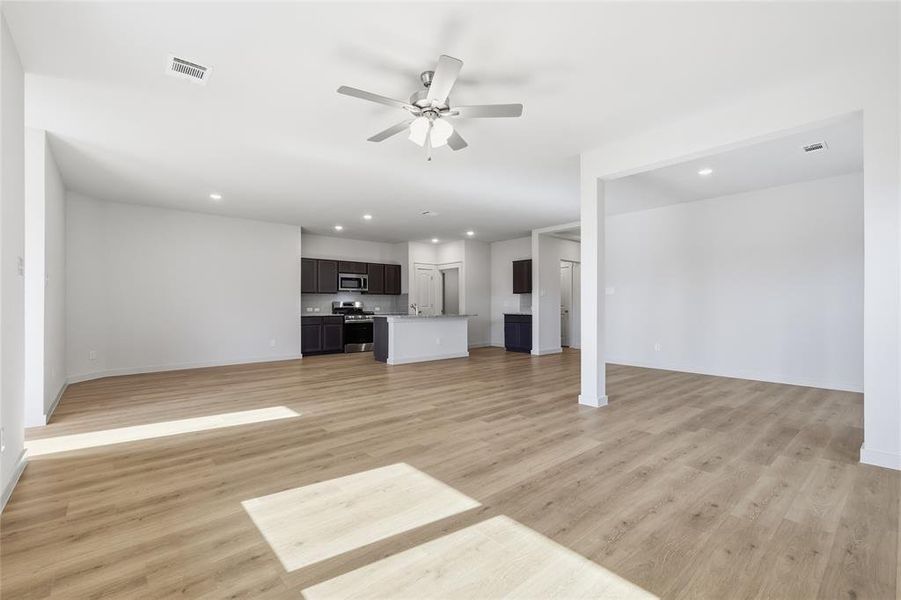 Unfurnished living room with recessed lighting, a ceiling fan, and light wood-style flooring