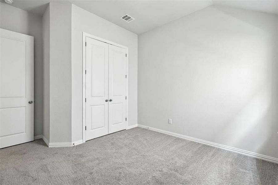 Unfurnished bedroom featuring carpet flooring and a closet