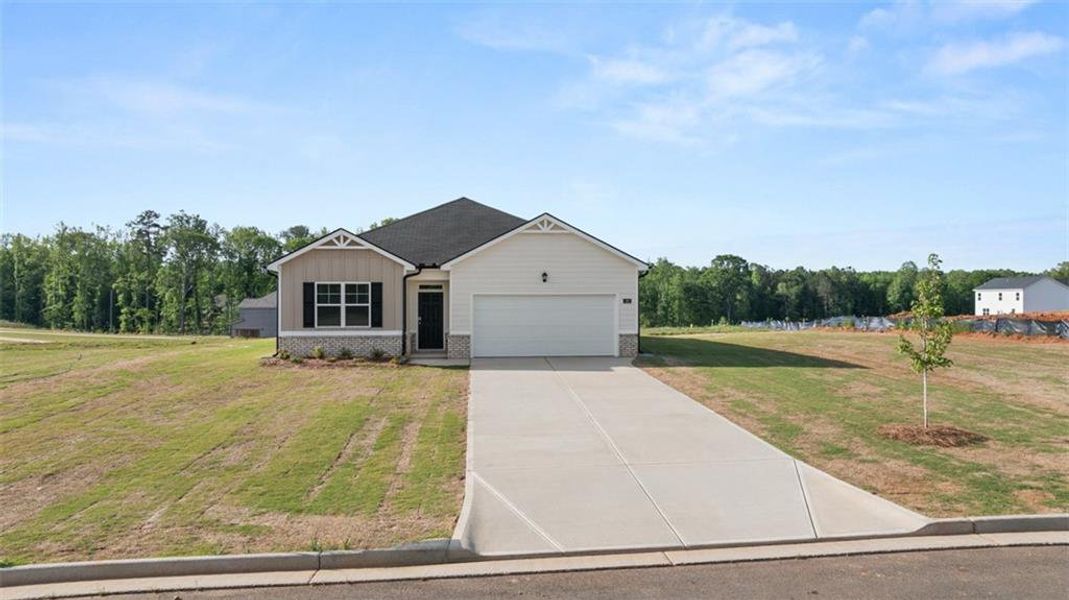 Front exterior of a new home in Champion's Run, Lithonia, GA, highlighting curb appeal (Image 1).