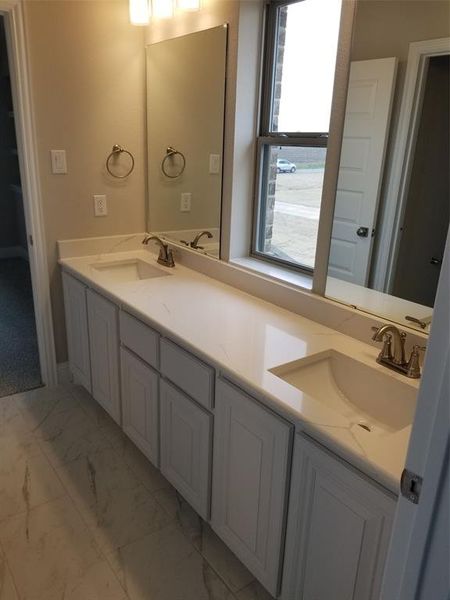 Jack & Jill bathroom with Quartz dual vanity separate from tub/ shower & commode makes it earsier to share.