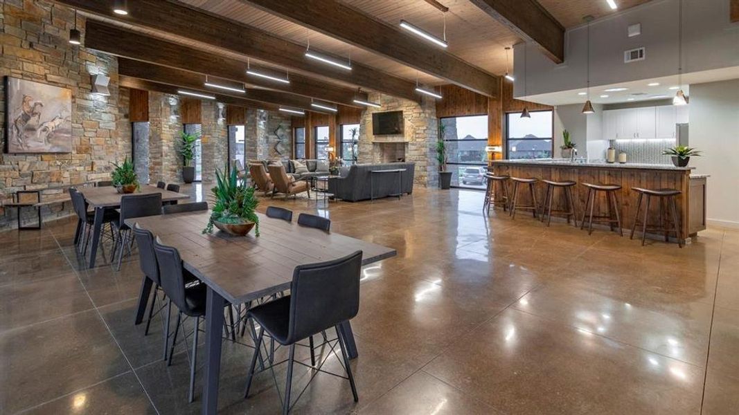 Dining space with a wooden ceiling with exposed beams and a high ceiling